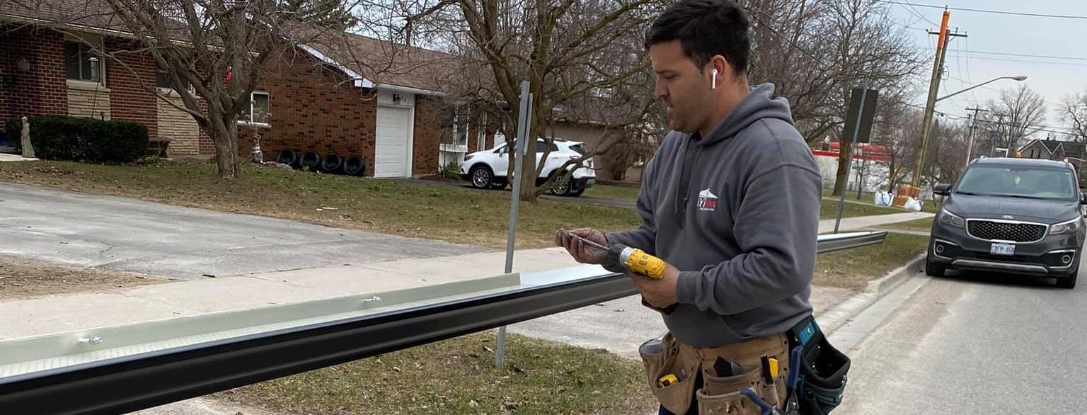 Faytrim employee working on an eavestrough.